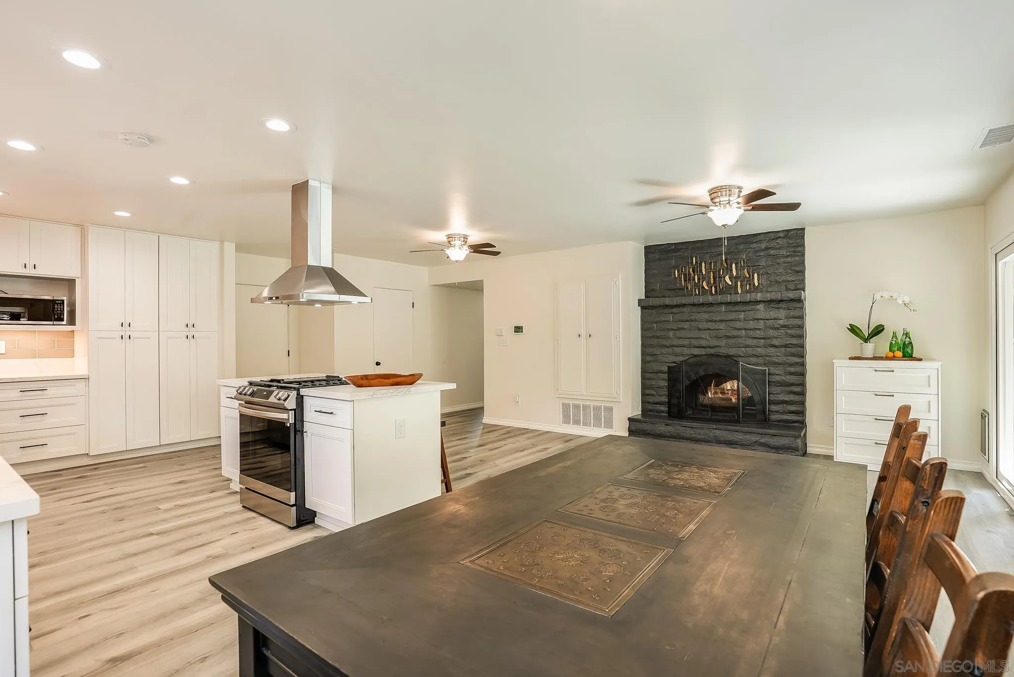 2211 Sunset Drive Escondido, CA 92025 - Photo 10 of 43 a open kitchen with cabinets and a fireplace