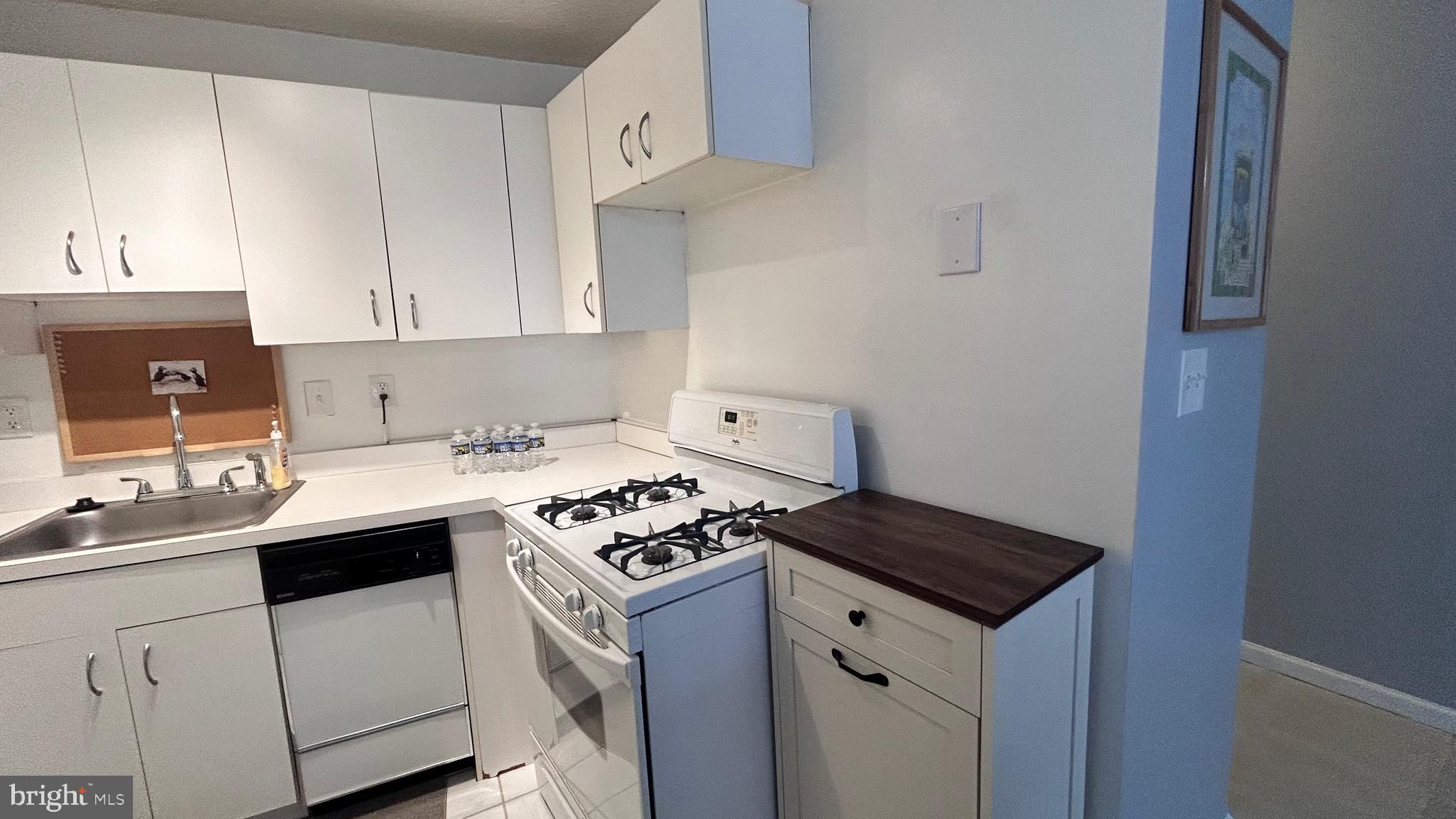 1239 Vermont Avenue Northwest, Unit 204 Washington, DC 20005 - Photo 12 of 39 a kitchen with a sink stove and cabinets