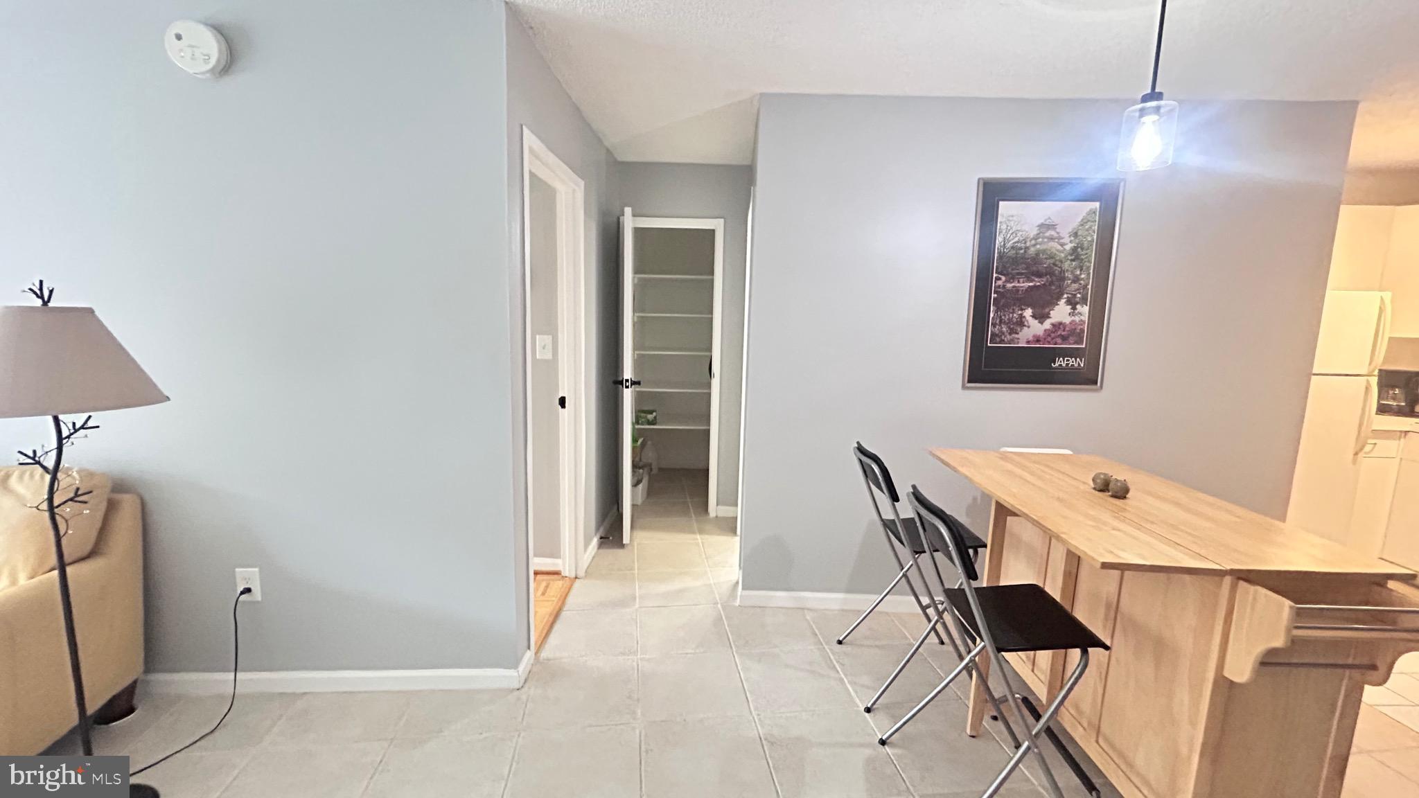 1239 Vermont Avenue Northwest, Unit 204 Washington, DC 20005 - Photo 15 of 39 a view of a workspace with furniture and a window