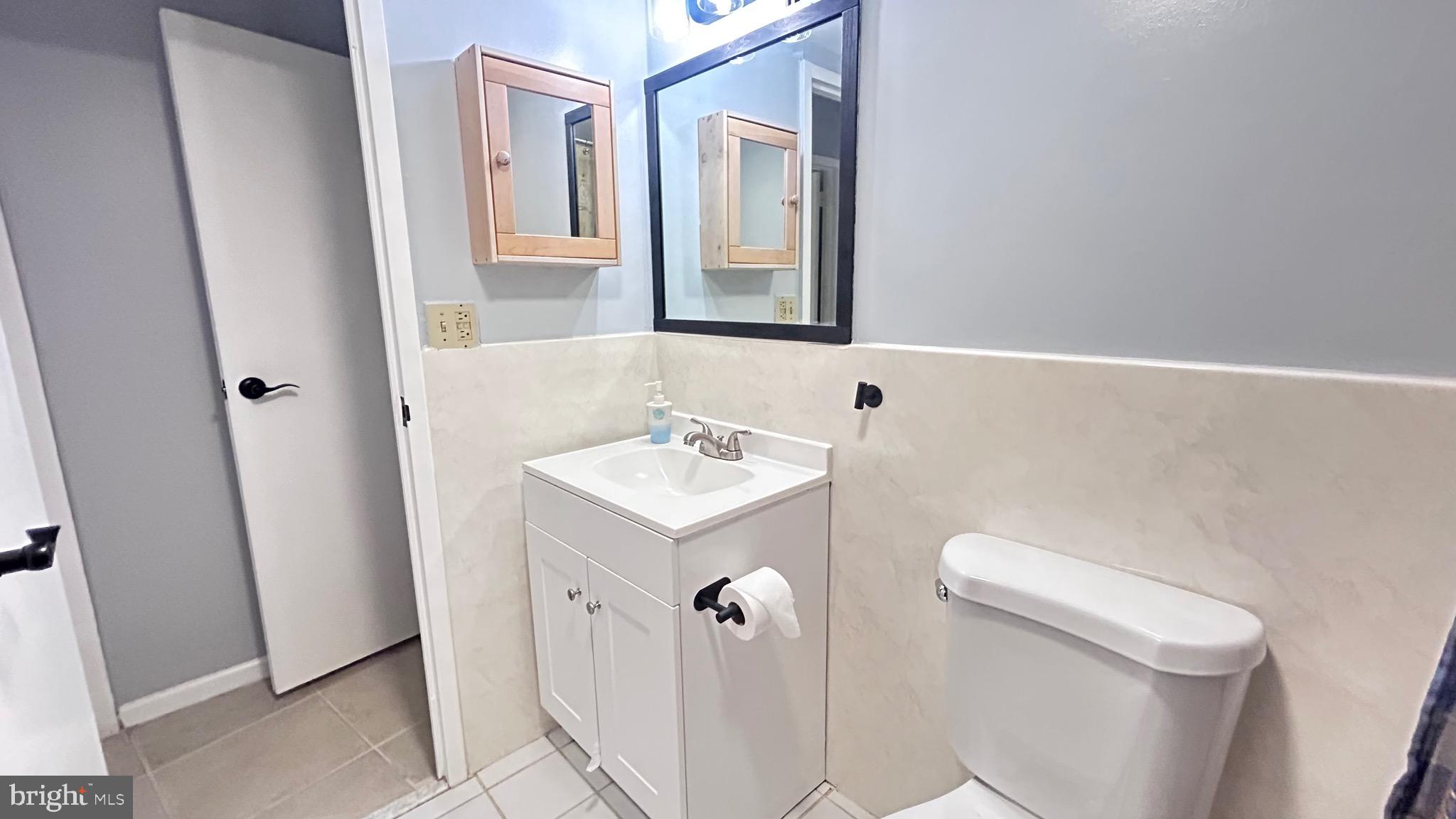 1239 Vermont Avenue Northwest, Unit 204 Washington, DC 20005 - Photo 22 of 39 a bathroom with a sink a toilet and mirror