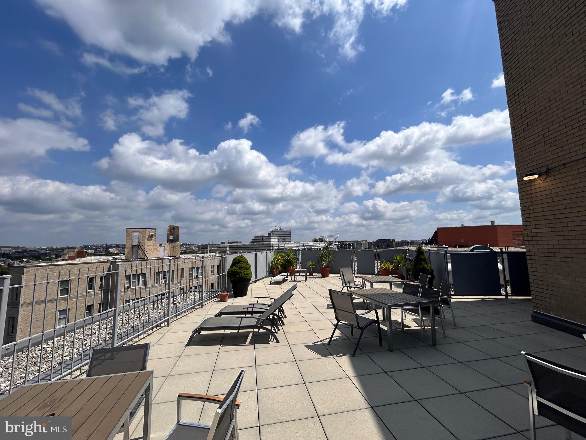 1239 Vermont Avenue Northwest, Unit 204 Washington, DC 20005 - Photo 26 of 39 a view of roof deck with table and chairs