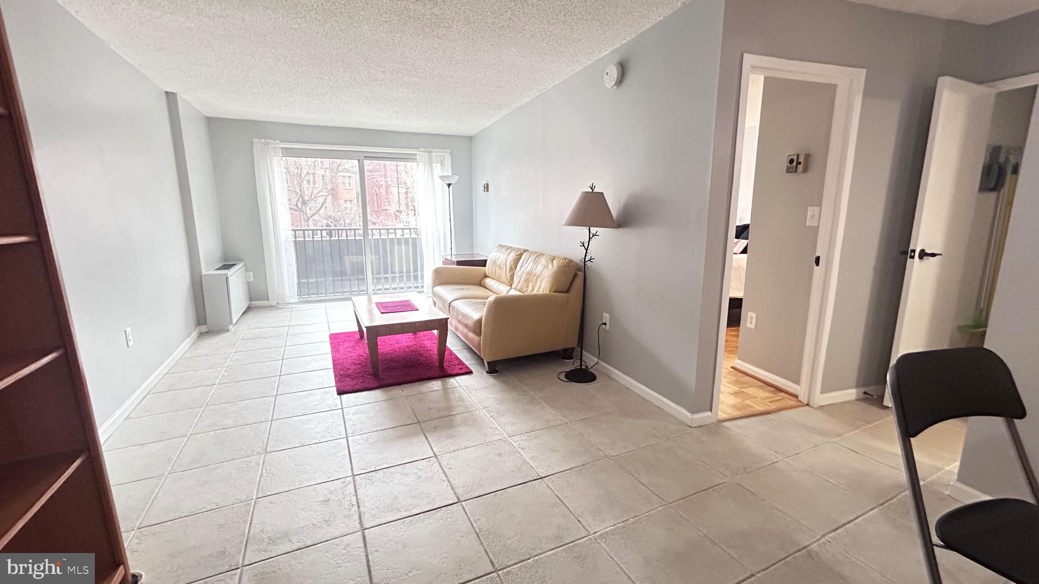 1239 Vermont Avenue Northwest, Unit 204 Washington, DC 20005 - Photo 5 of 39 a bedroom with furniture and a window