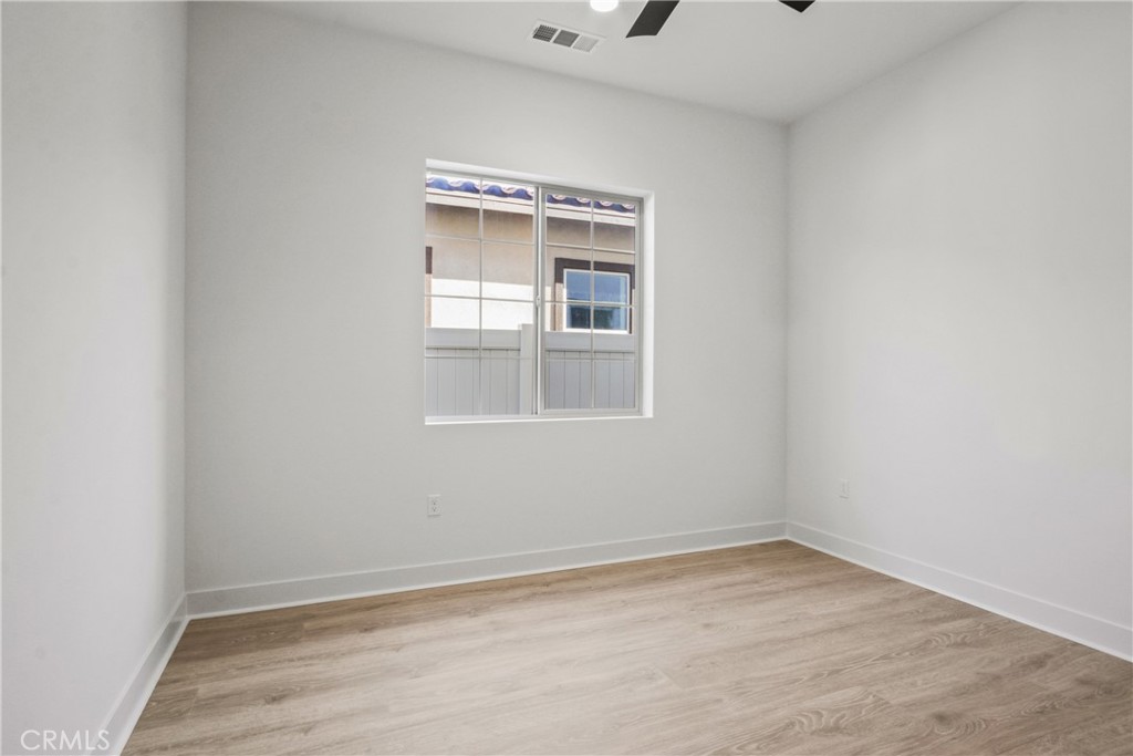 4685 Avondale Court Chino, CA 91710 - Photo 12 of 16 a view of an empty room with wooden floor and a window