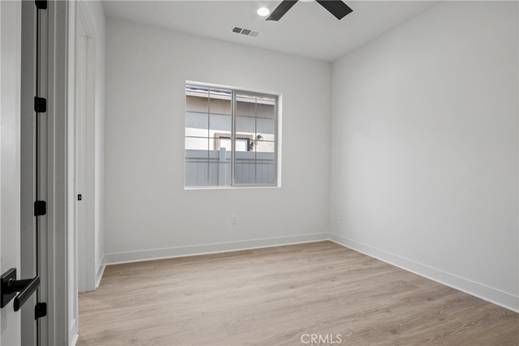 4685 Avondale Court Chino, CA 91710 - Photo 13 of 16 a view of an empty room with wooden floor and a window
