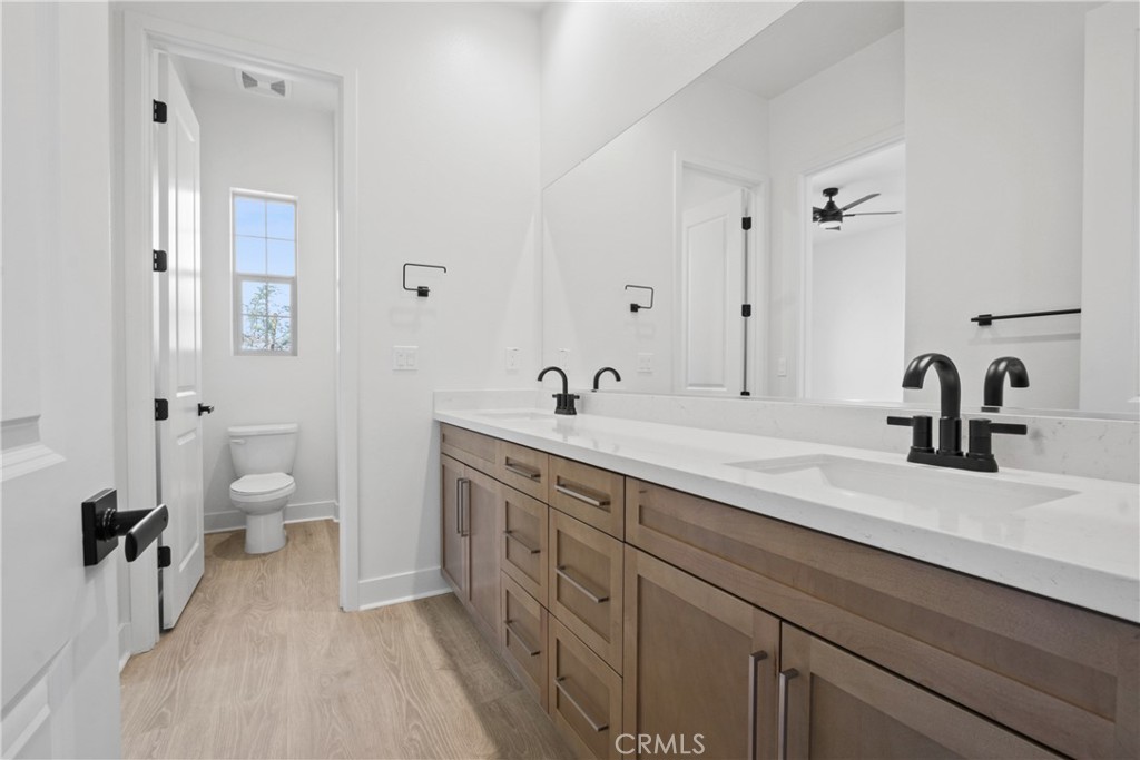 4685 Avondale Court Chino, CA 91710 - Photo 14 of 16 a spacious bathroom with a double vanity sink mirror and toilet