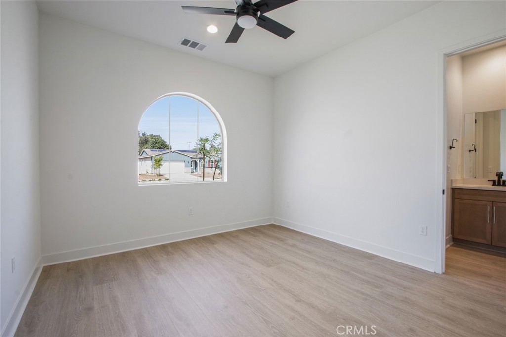 4685 Avondale Court Chino, CA 91710 - Photo 15 of 16 an empty room with wooden floor ceiling fan and windows