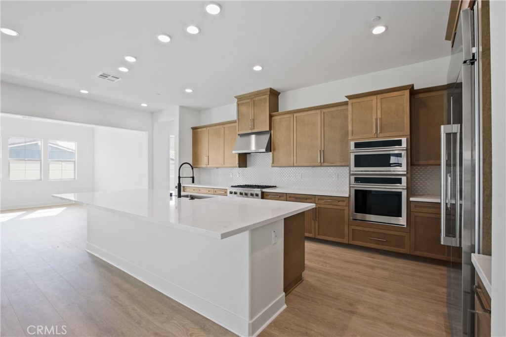 4685 Avondale Court Chino, CA 91710 - Photo 5 of 16 a large kitchen with stainless steel appliances