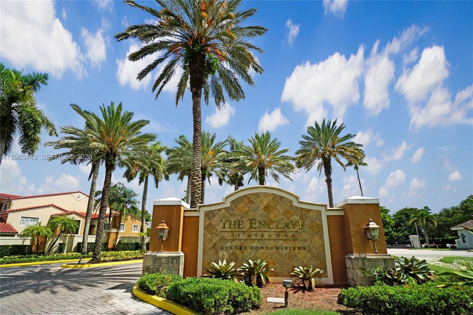 a front view of multi story residential apartment building with yard and sign board