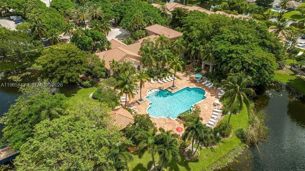 2031 Renaissance Boulevard, Unit 106 Miramar, FL 33025 - Photo 12 of 19 a backyard of a house with a yard and outdoor seating