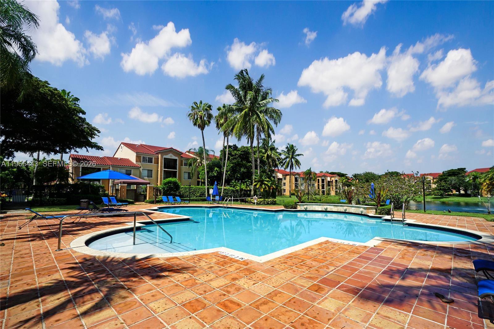 2031 Renaissance Boulevard, Unit 106 Miramar, FL 33025 - Photo 2 of 19 a view of swimming pool and lake view