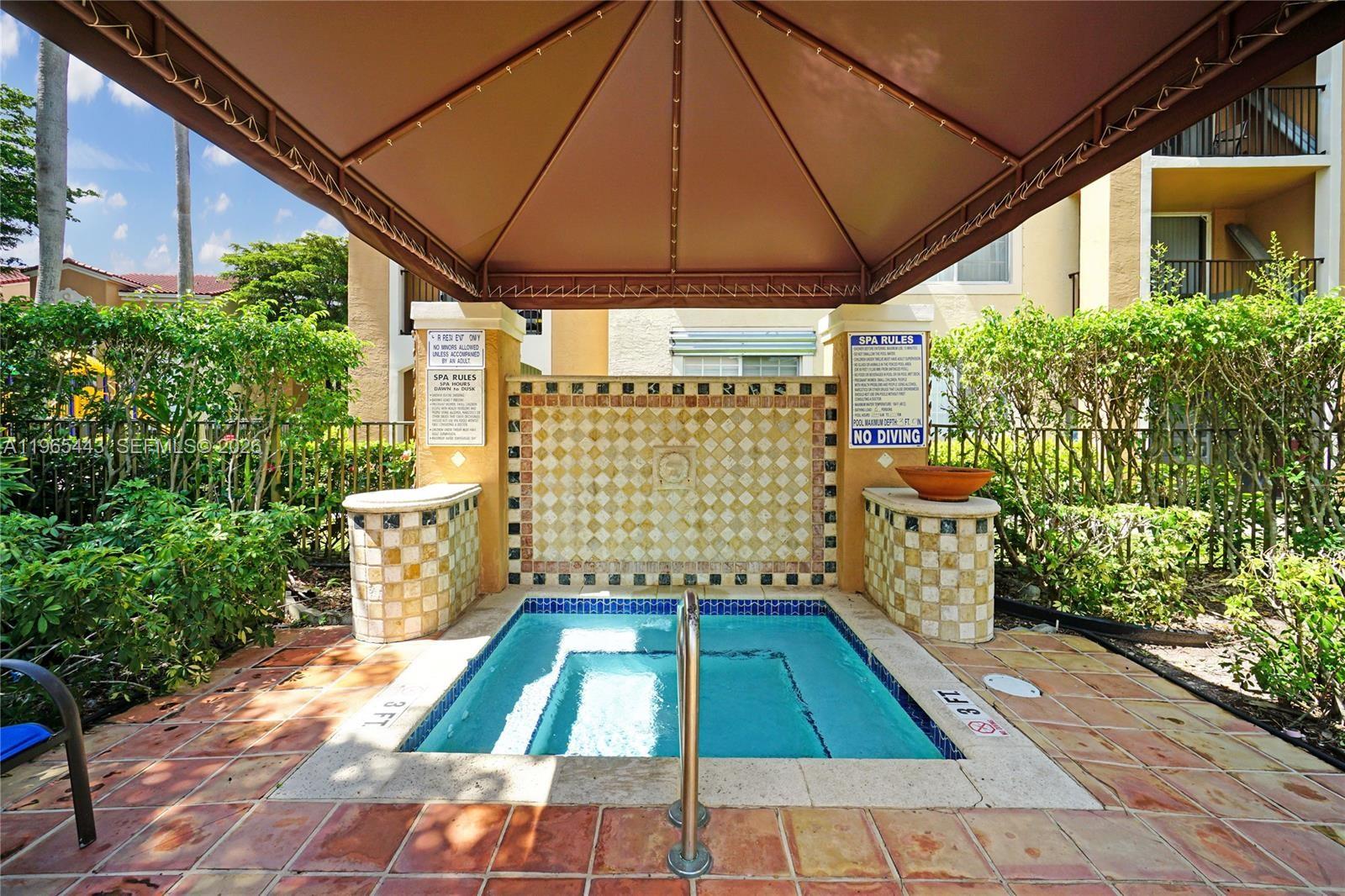 2031 Renaissance Boulevard, Unit 106 Miramar, FL 33025 - Photo 3 of 19 a room with garden and patio