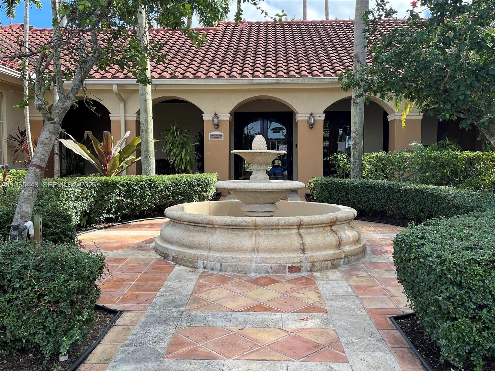 2031 Renaissance Boulevard, Unit 106 Miramar, FL 33025 - Photo 7 of 19 a view of a white house with a yard