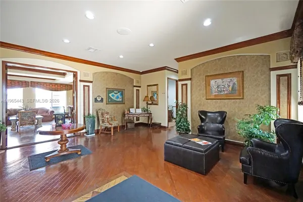 a living room with furniture and wooden floor