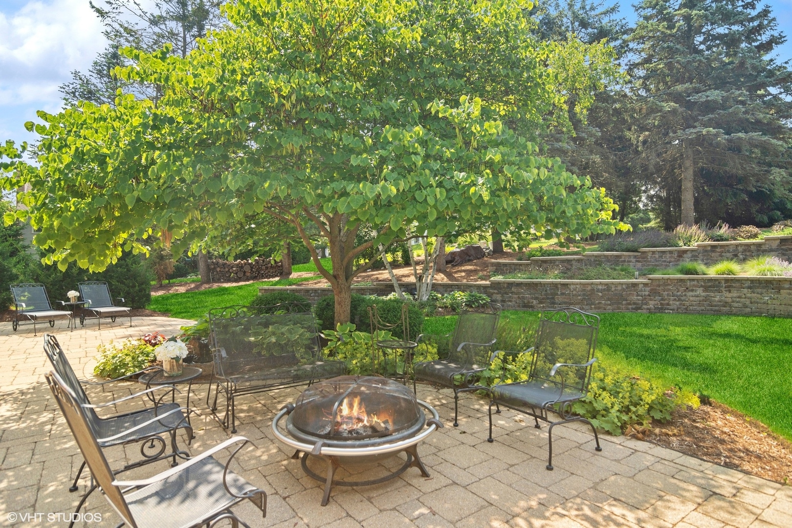 716 Saddle Ridge Crystal Lake, IL 60012 - Photo 28 of 42 a view of a backyard with sitting area and garden