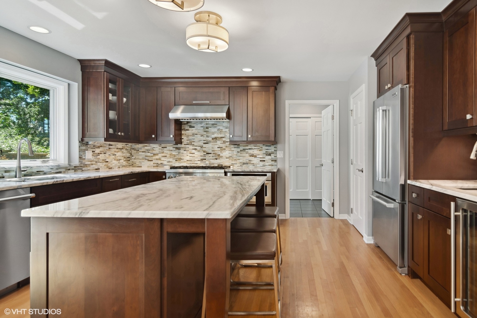716 Saddle Ridge Crystal Lake, IL 60012 - Photo 4 of 42 a kitchen with kitchen island granite countertop wooden cabinets and refrigerator