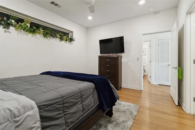 a bedroom with a bed and a flat screen tv