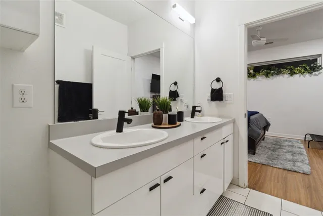 a bathroom with a double vanity sink and a mirror