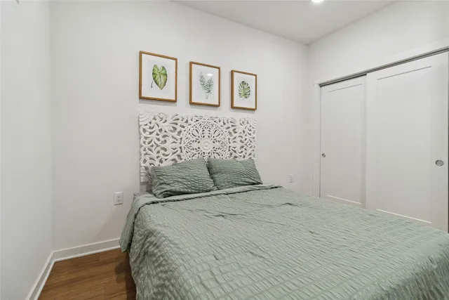 a bedroom with a bed and wall painting