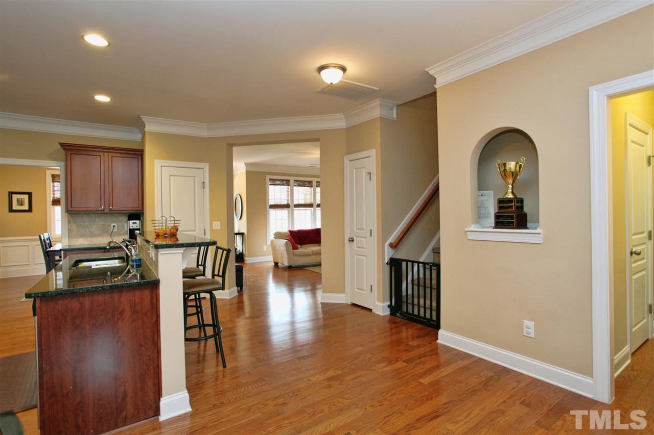 618 Democracy Street Raleigh, NC 27603 - Photo 10 of 24 a view of a kitchen with furniture and wooden floor