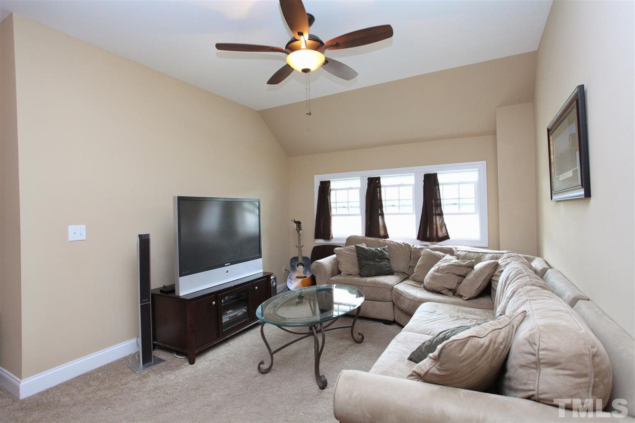 618 Democracy Street Raleigh, NC 27603 - Photo 12 of 24 a living room with furniture and a flat screen tv