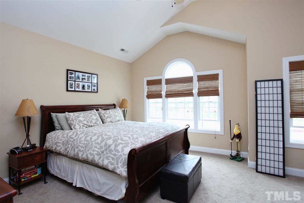 618 Democracy Street Raleigh, NC 27603 - Photo 14 of 24 a bedroom with a bed and a large window