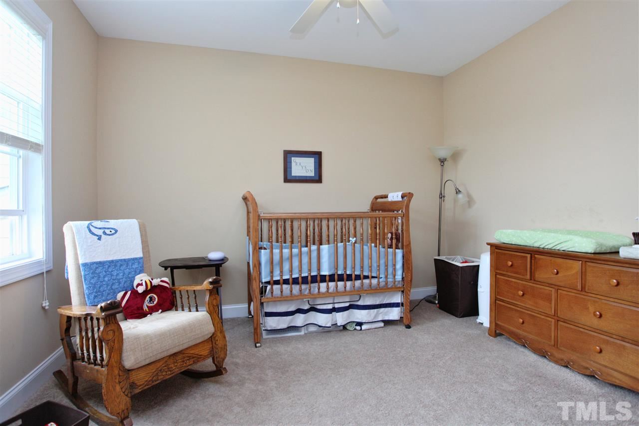 618 Democracy Street Raleigh, NC 27603 - Photo 17 of 24 a bedroom with furniture and window