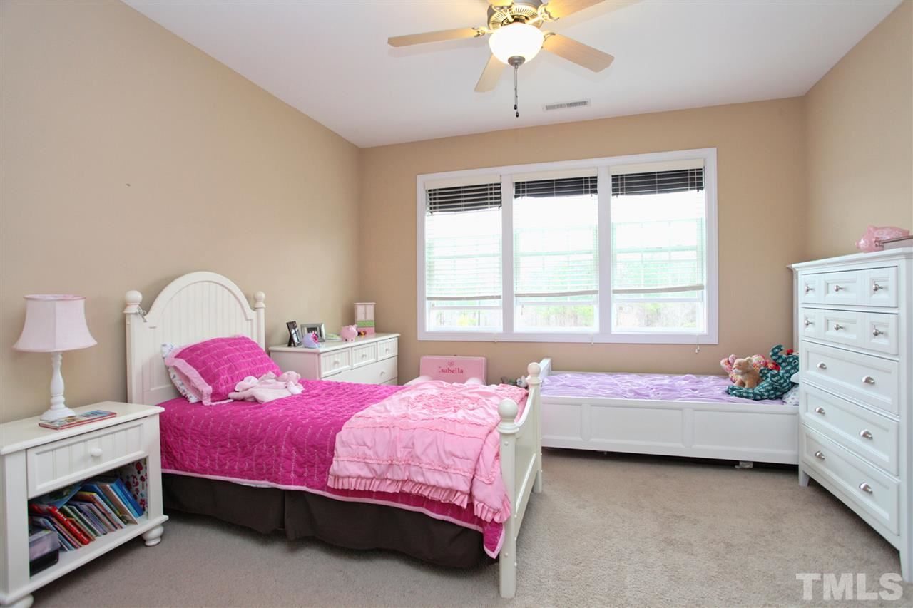 618 Democracy Street Raleigh, NC 27603 - Photo 18 of 24 a bedroom with a bed and a dresser