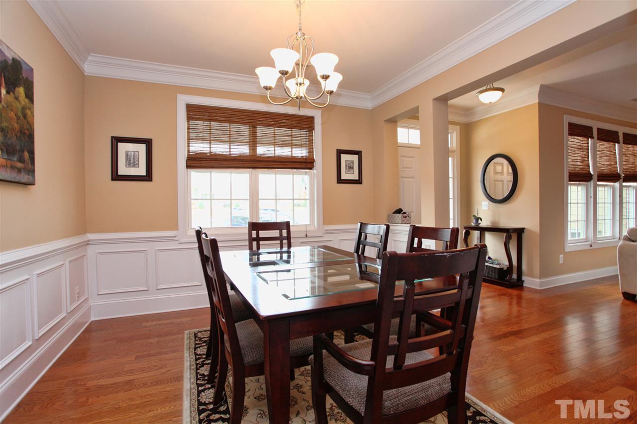 618 Democracy Street Raleigh, NC 27603 - Photo 3 of 24 a view of a dining room with furniture window and wooden floor