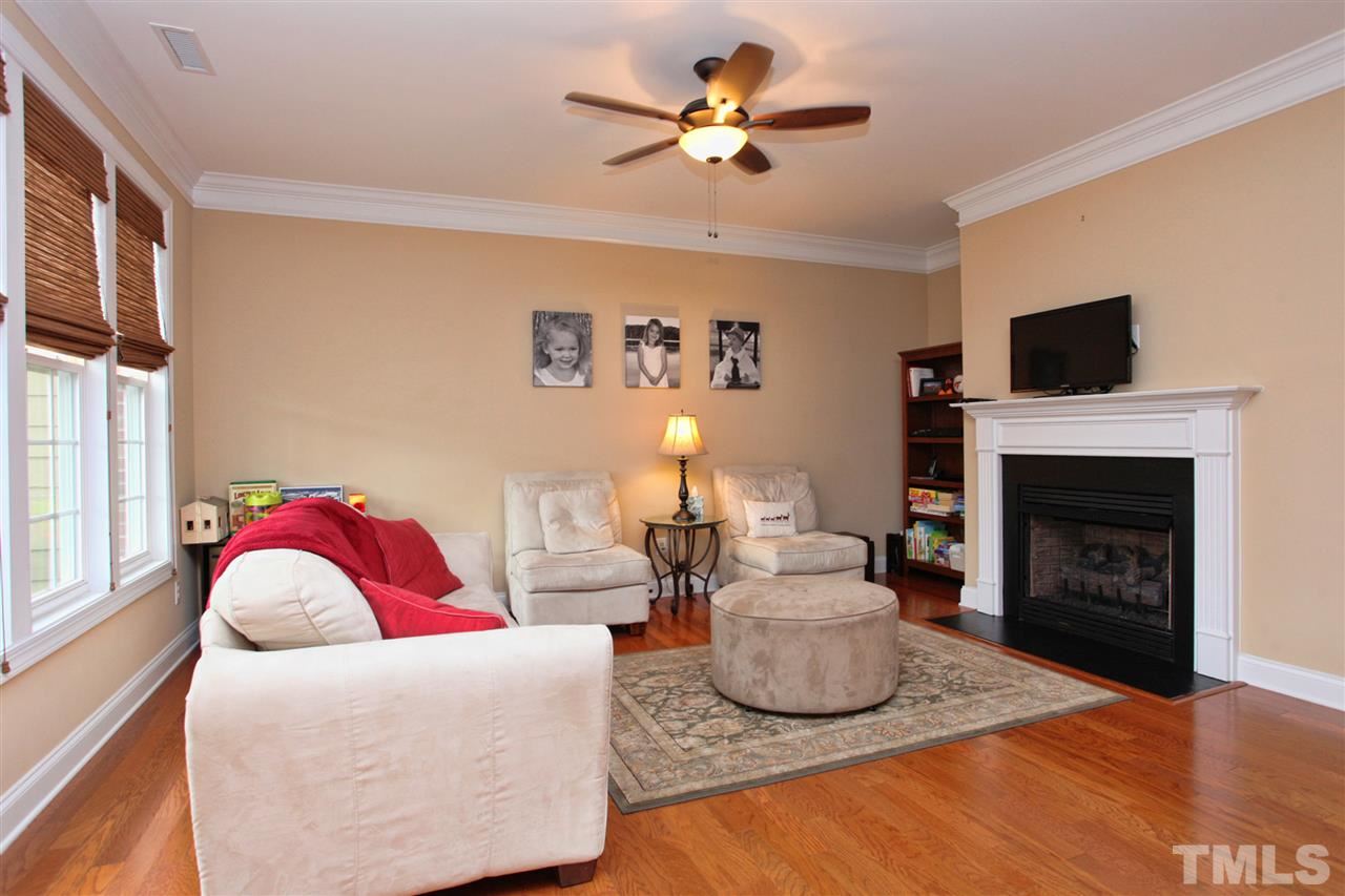 618 Democracy Street Raleigh, NC 27603 - Photo 4 of 24 a living room with furniture a fireplace and a flat screen tv