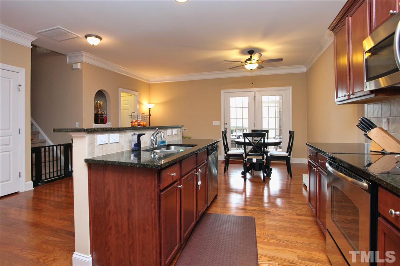 618 Democracy Street Raleigh, NC 27603 - Photo 6 of 24 a kitchen with lots of counter top space and dining table