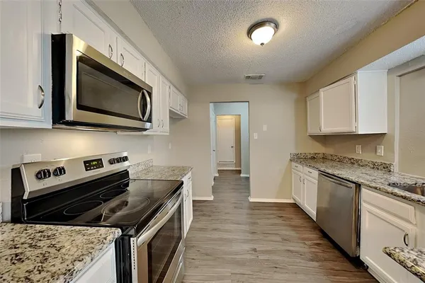 a kitchen with a stove microwave and sink