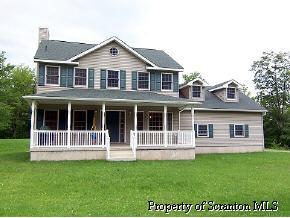 2049 Johnson Hl Road Hop Bottom, PA 18824 - Photo 1 of 6 a front view of a house with a garden