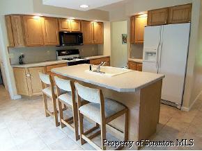 2049 Johnson Hl Road Hop Bottom, PA 18824 - Photo 3 of 6 a kitchen with stainless steel appliances kitchen island granite countertop a refrigerator a stove a microwave oven a sink with island and chairs