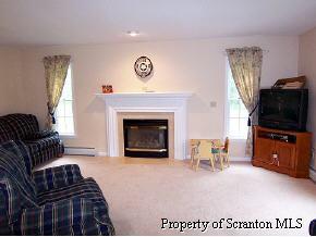 2049 Johnson Hl Road Hop Bottom, PA 18824 - Photo 6 of 6 a living room with furniture a flat screen tv and a fireplace