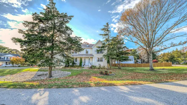 a view of a house with swimming pool and a yard