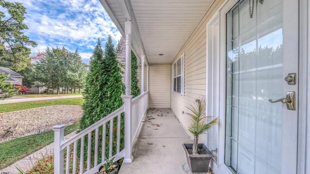 a view of a hallway with wooden floor and stairs