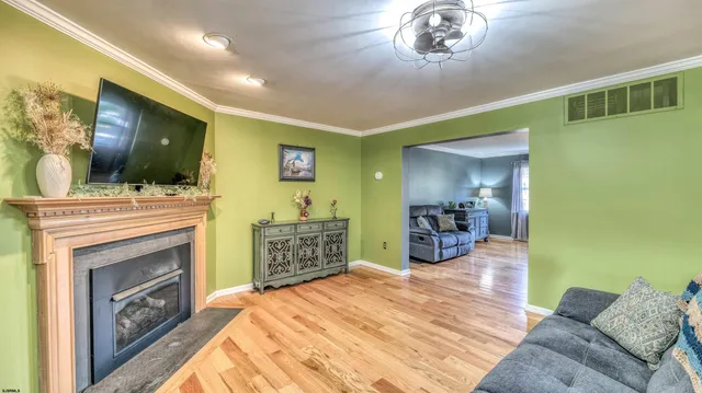 a dining room with furniture and a kitchen view