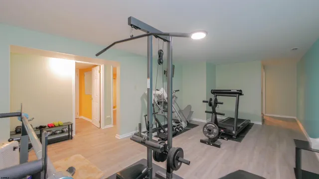 a view of a house with a yard and large trees