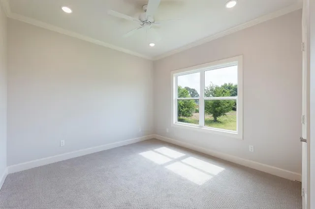 an empty room with windows and closet