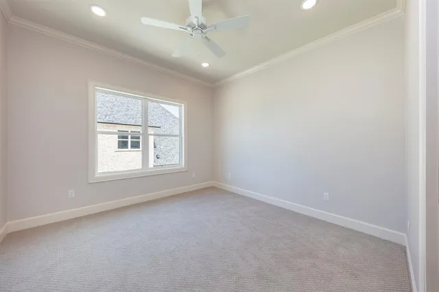 an empty room with a window and ceiling fan
