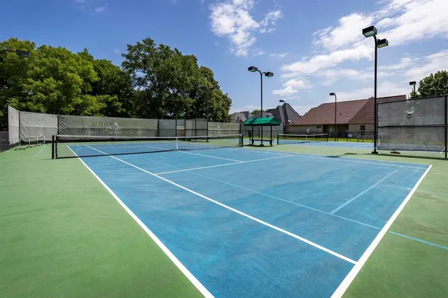 a tennis court that has potted plants