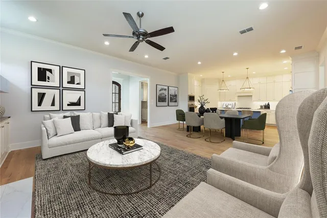 a living room with furniture and view of kitchen