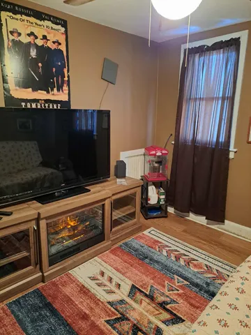 a bedroom with a bed and flat screen tv