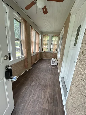 a view of a room with wooden floor and staircase