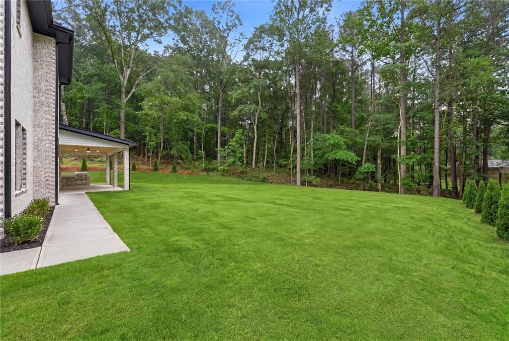 1563 Whitley Road Dacula, GA 30019 - Photo 39 of 44 a view of a backyard with a garden