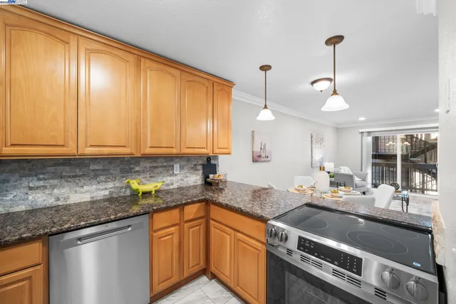 a kitchen with stainless steel appliances granite countertop a sink stove and cabinets