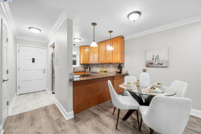 a kitchen with granite countertop white cabinets and stainless steel appliances