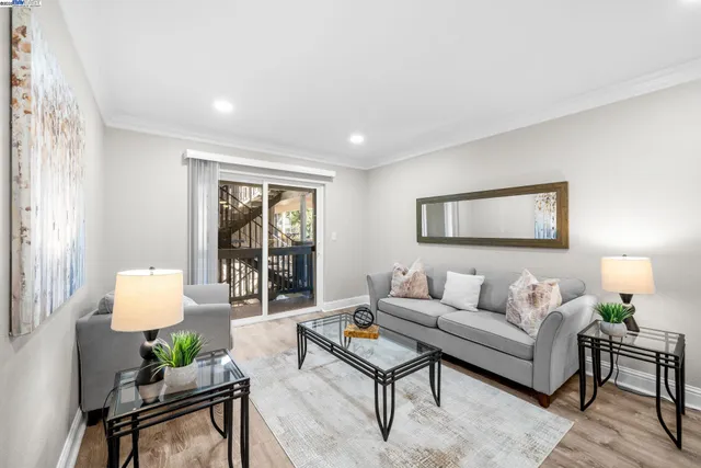 a living room with furniture and a potted plant on table