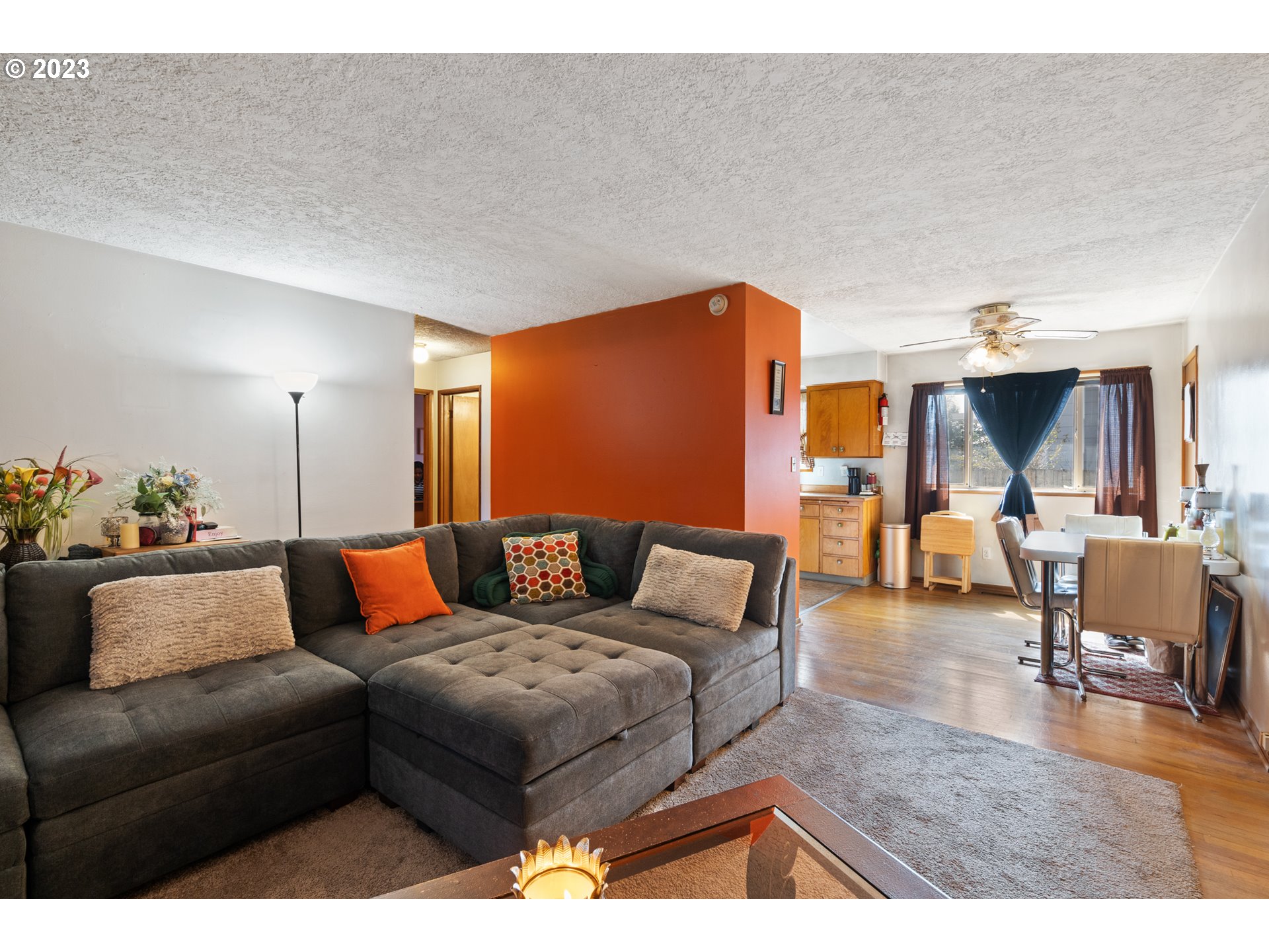 3832 North Kilpatrick Street Portland, OR 97217 - Photo 19 of 34 a living room with furniture and a dining table with wooden floor