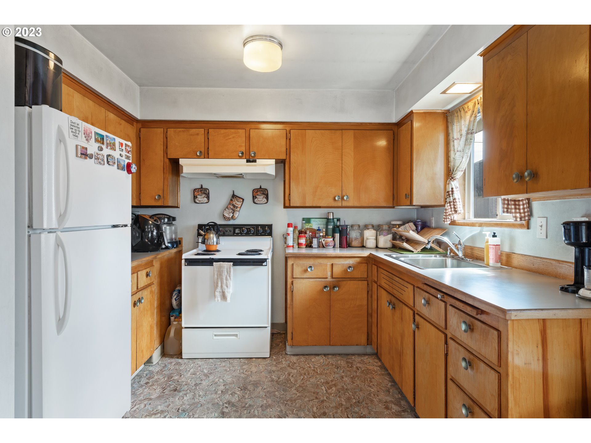 3832 North Kilpatrick Street Portland, OR 97217 - Photo 20 of 34 a kitchen with stainless steel appliances a refrigerator sink and cabinets